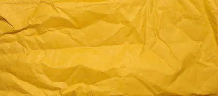 yellow sheet of paper with visible texture. backgroundの写真素材