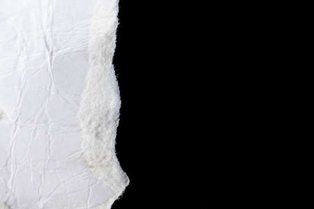 a white piece of paper on a black isolated background