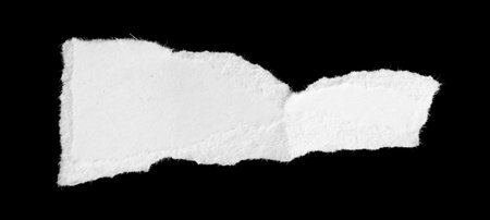 a white piece of paper on a black isolated backgroundの写真素材