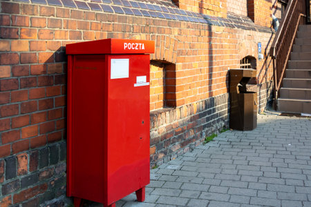 red mailbox on a red brick wall