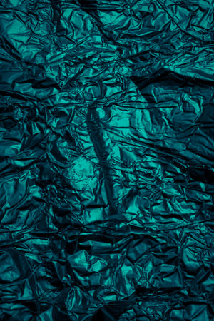 crinkled blue foil with visible details. background or textureの写真素材