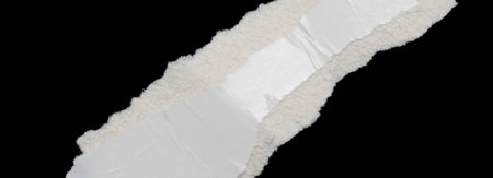 a white piece of paper on a black isolated backgroundの写真素材