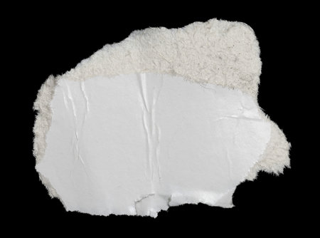 a white piece of paper on a black isolated backgroundの写真素材