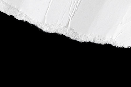 a white piece of paper on a black isolated backgroundの写真素材