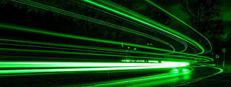 green lines of car lights on black backgroundの写真素材