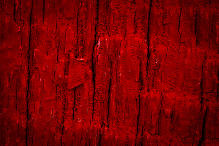 old cracked wood painted red. background or texture