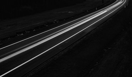 white lines of car lights on black background