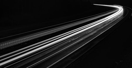 white lines of car lights on black backgroundの写真素材