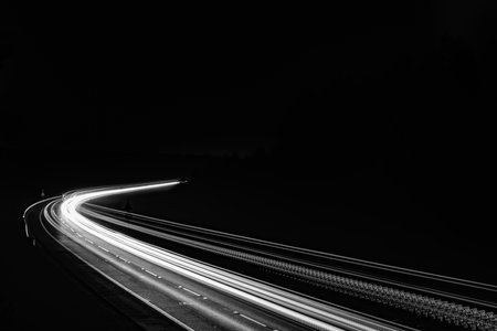 white lines of car lights on black backgroundの写真素材