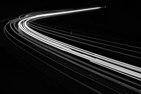 white lines of car lights on black backgroundの写真素材
