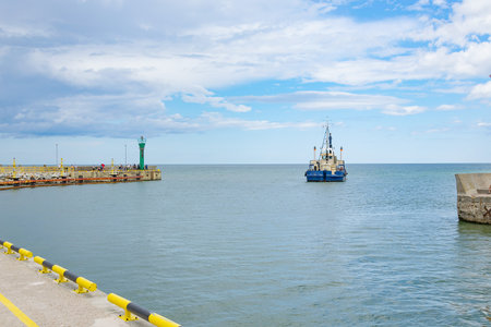 ship with excavator for dredging the entrance to the portの写真素材