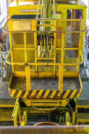 yellow lifting basket with visible detailsの写真素材