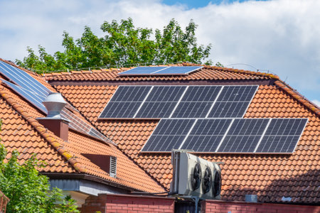photovoltaic panels on a red tile roofの写真素材