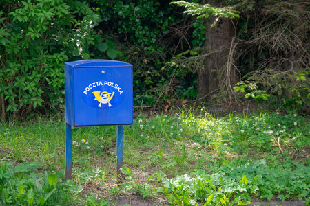 Ustka, Poland - 26/06/2024 - blue mailbox of the Polish Post Office in Ustkaのeditorial素材