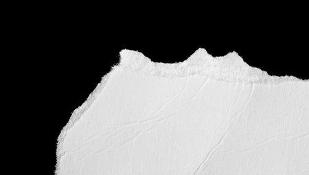 a white piece of paper on a black isolated backgroundの写真素材
