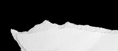 a white piece of paper on a black isolated backgroundの写真素材