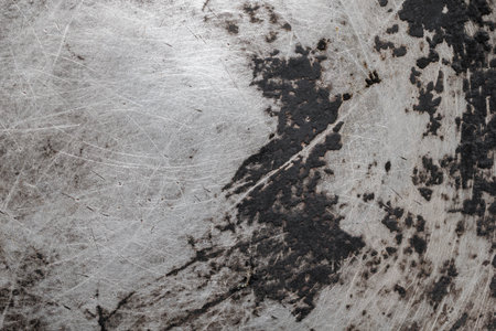 old aluminum sheet with burnt marks from the panの写真素材