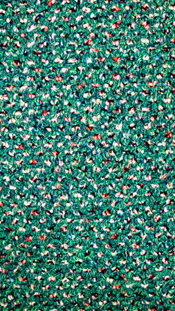 green wool fabric with white, red and black dotsの写真素材