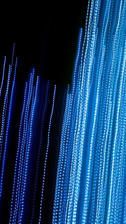 blue dashed lines of lights on a black backgroundの写真素材