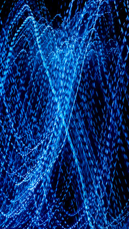 blue dashed lines of lights on a black backgroundの写真素材