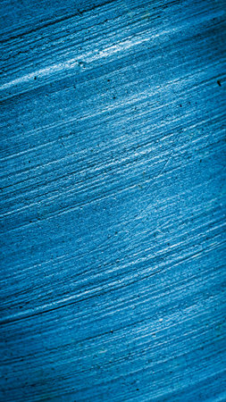 old wall painted with blue paint with visible texture