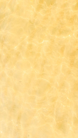 reflection of light in sea water on a background of yellow sandの写真素材