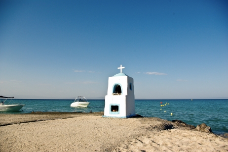 Sign from a stone with a cross on sandy to seacoastの写真素材