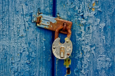 Door covered by a dark blue paint closed on  lockの写真素材