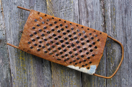 Old tool for  vegetables which hangs on a wooden wallの写真素材