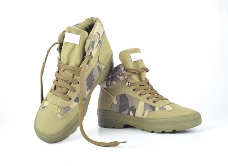 A pair of camouflage baseball boots against white backgroundの写真素材