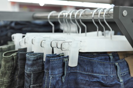 Close up of jeans on a rackの写真素材