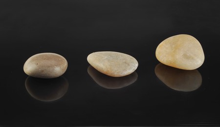 Three pebbles in the black backgroundの写真素材