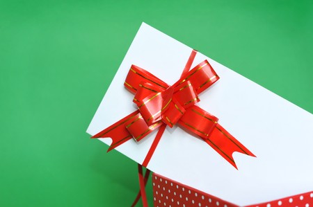 Green background with present box and greeting cardの写真素材