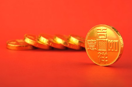 Gold coins on a red backgroundの写真素材