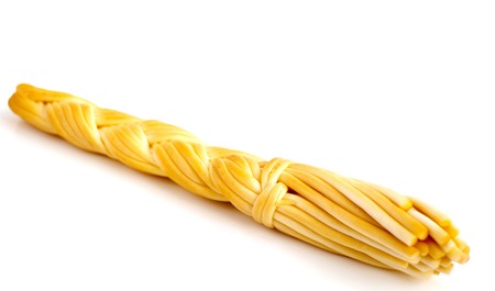 Smoked cheese a plait on a white background