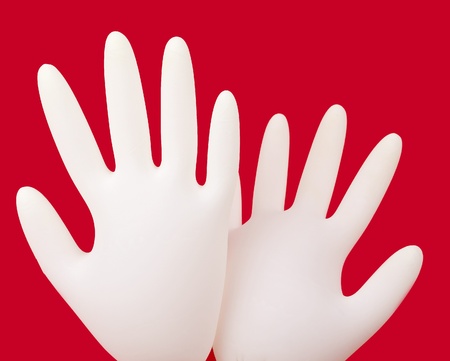 medical gloves on red backgroundの写真素材