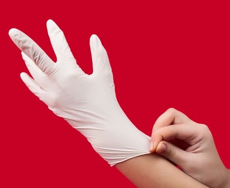 medical gloves on red backgroundの写真素材