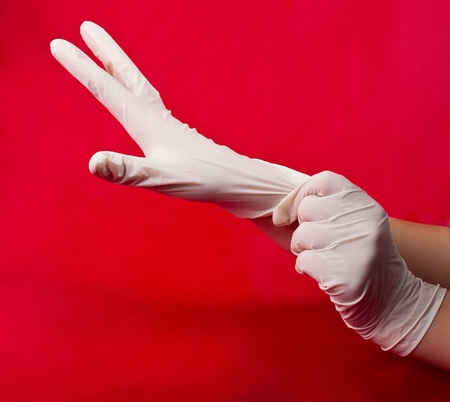 medical gloves on red backgroundの写真素材