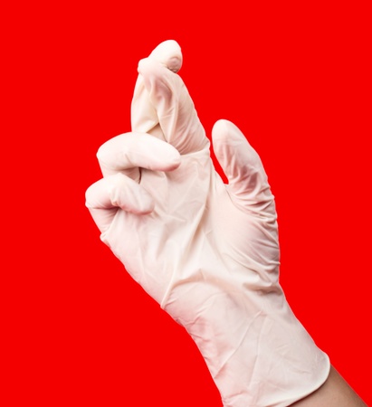 gloved handon a red backgroundの写真素材