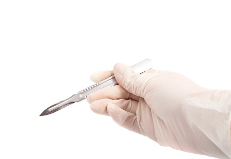 Hand holding scalpel isolated on whiteの写真素材