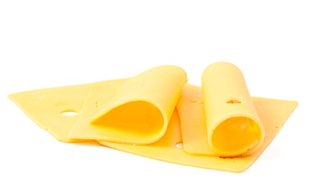 sliced cheese on a white backgroundの写真素材