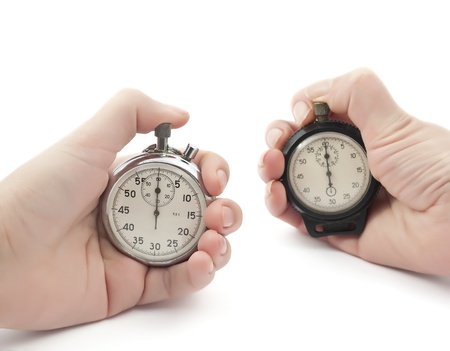 stopwatches in their hands on a white backgroundの写真素材