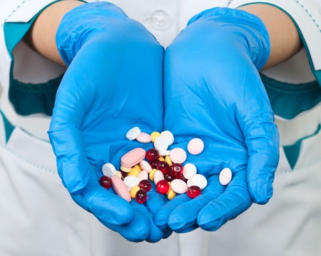 drugs in the hands of a doctor on a white backgroundの写真素材