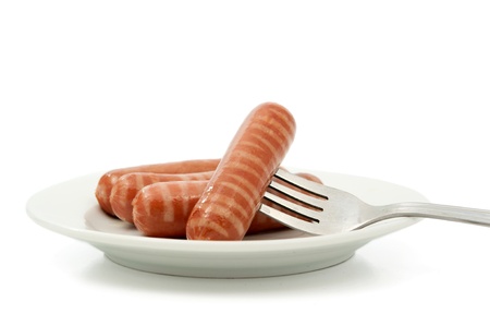 sausages in a dish on a white backgroundの写真素材