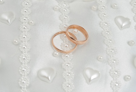 wedding rings on a white pillow