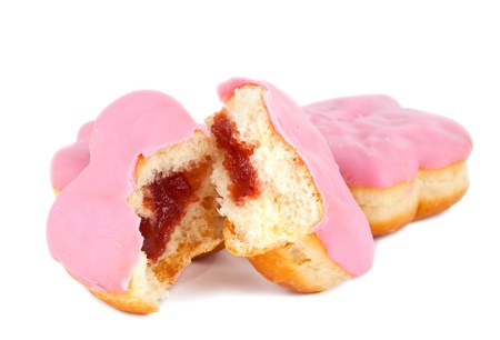 donut with pink frosting on white backgroundの写真素材