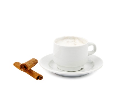 Cup of coffee with milk and cinnamon isolated over whte backgroundの写真素材