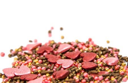 Sprinkle with heart decoration on white background