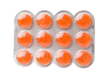 Packaging of orange pills isolated on white background