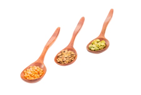 pulses in a wooden spoon isolated on a white backgroundの写真素材